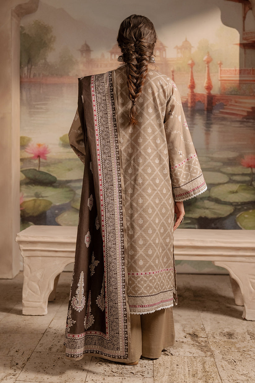 Person wearing a traditional outfit with intricate patterns in a decorative setting.