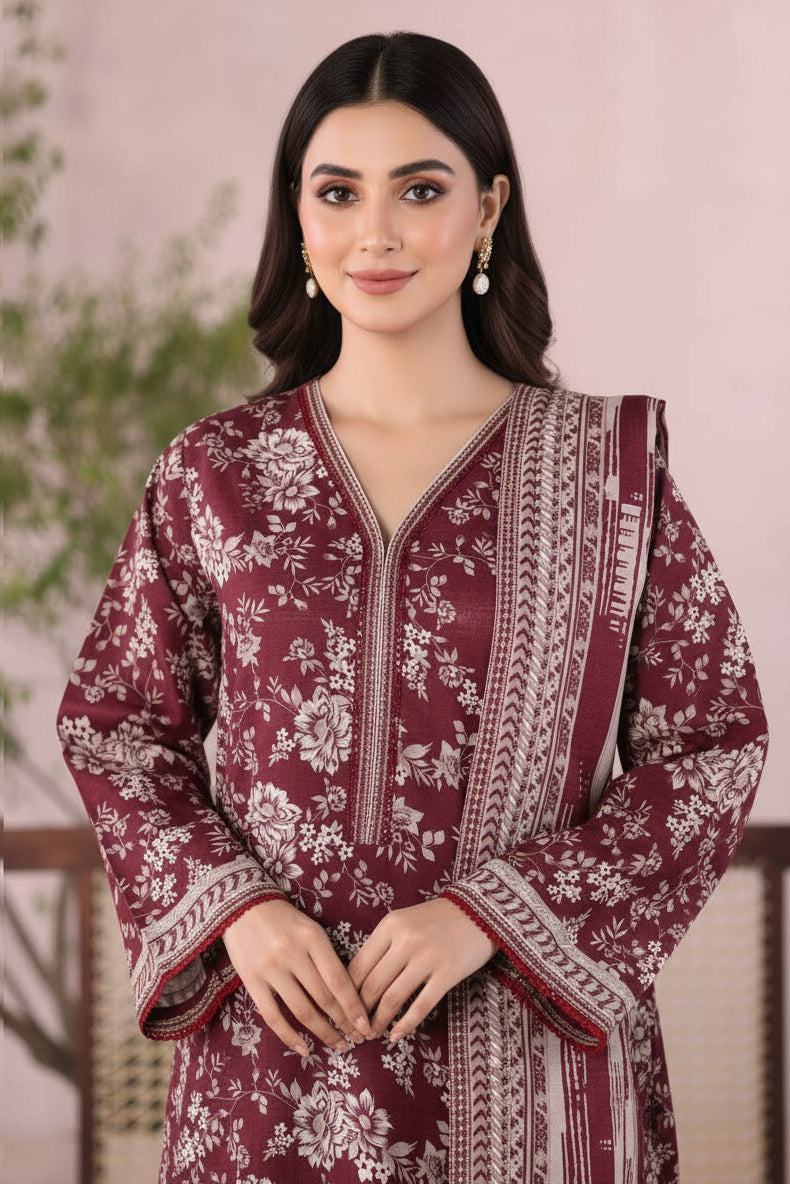 Maroon and white floral embroidered traditional outfit on a woman model against a neutral background
