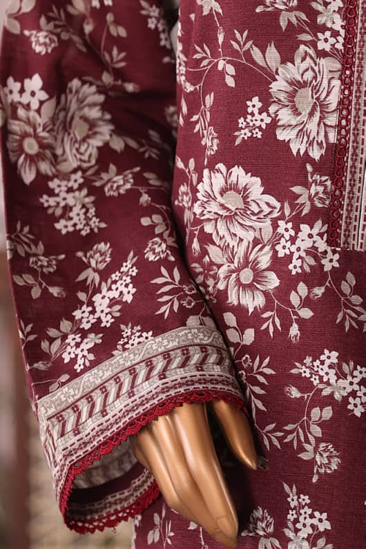 Maroon fabric with white floral pattern on a woman model arm