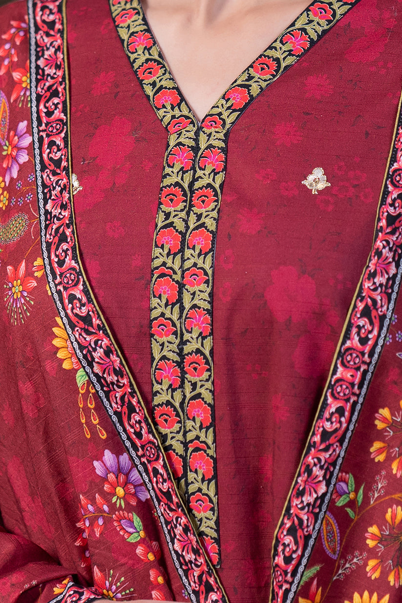 Red embroidered garment with floral patterns on a blurred background