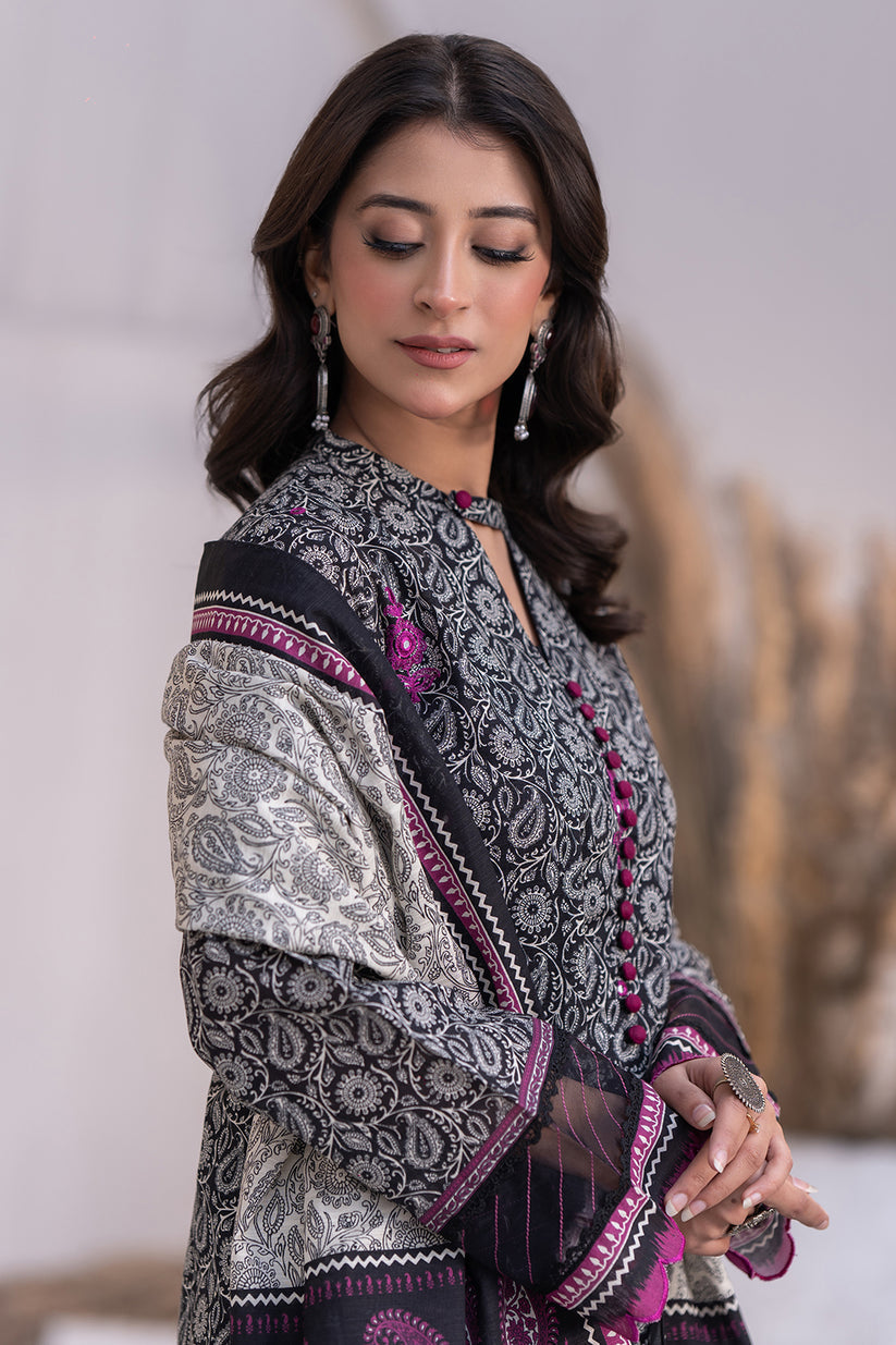 Woman wearing a traditional embroidered outfit with intricate patterns