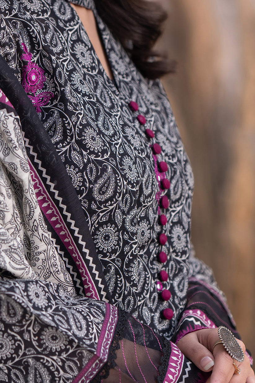 Close-up of a woman wearing a patterned outfit with intricate designs and colors.