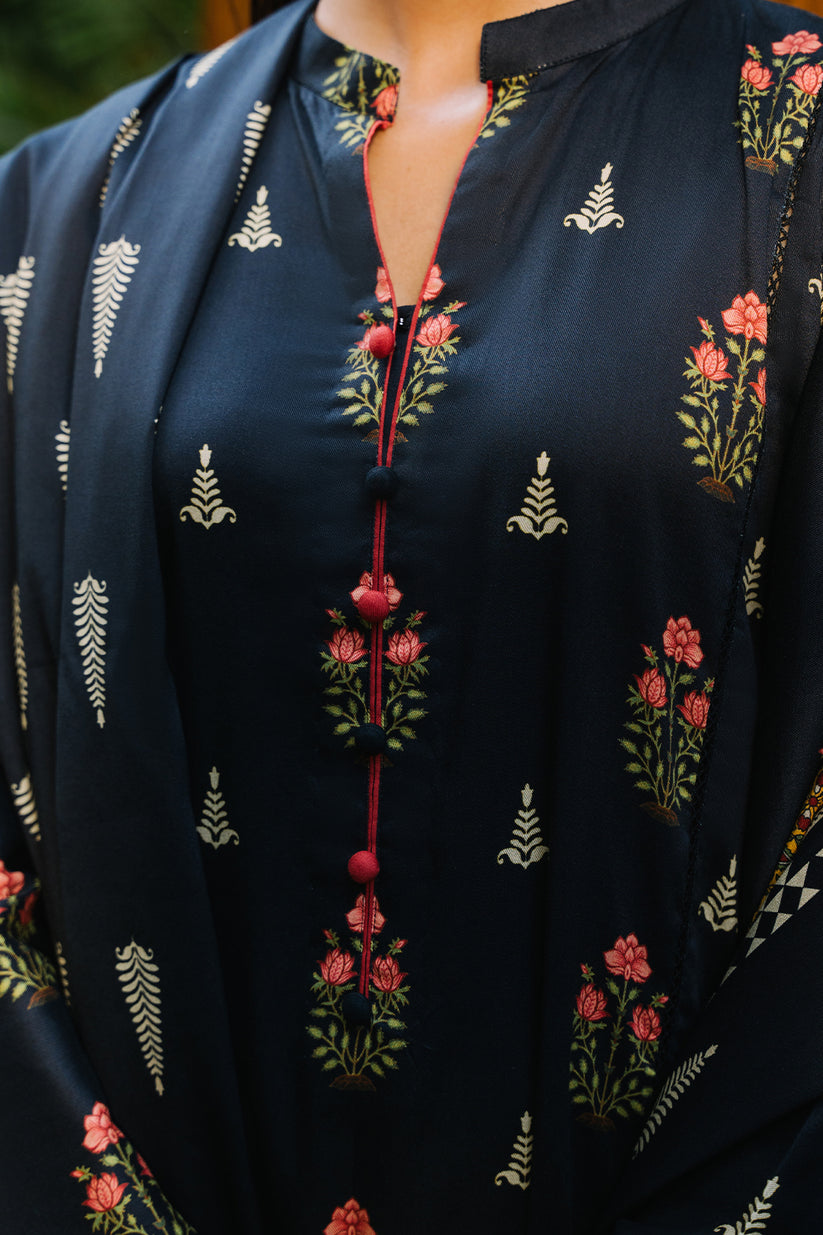 Black embroidered blouse with floral patterns on a blurred background