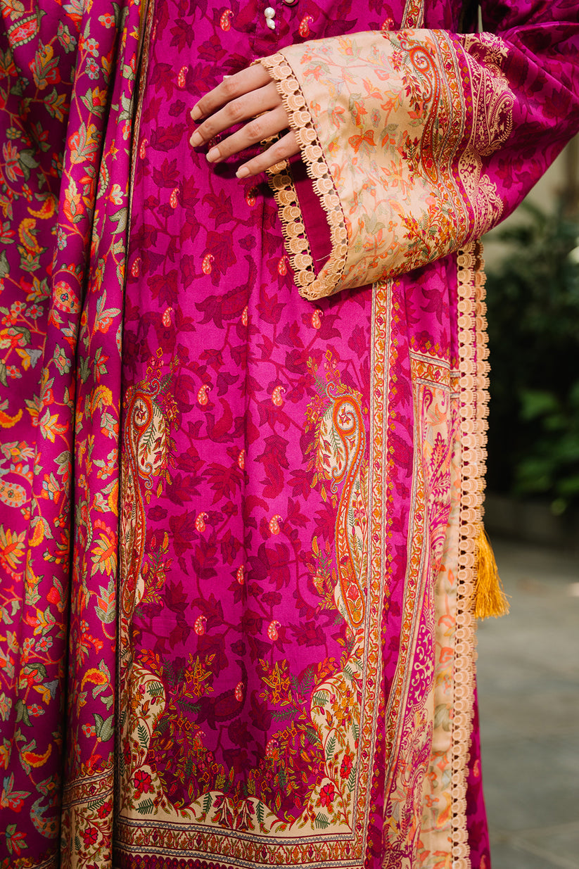 Close-up of a vibrant pink traditional outfit with intricate patterns and embroidery.