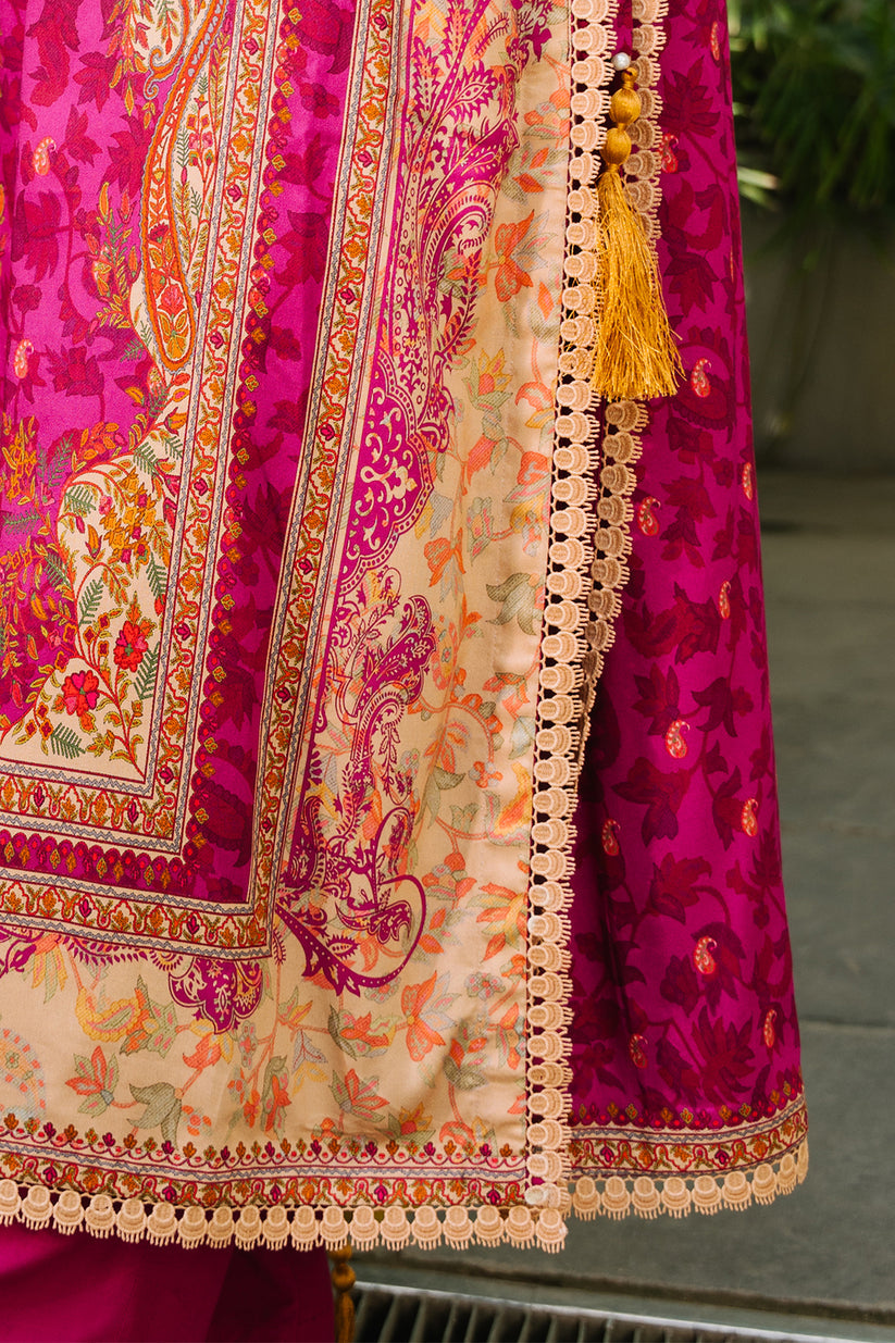 Close-up of a vibrant pink and orange traditional fabric with intricate patterns.