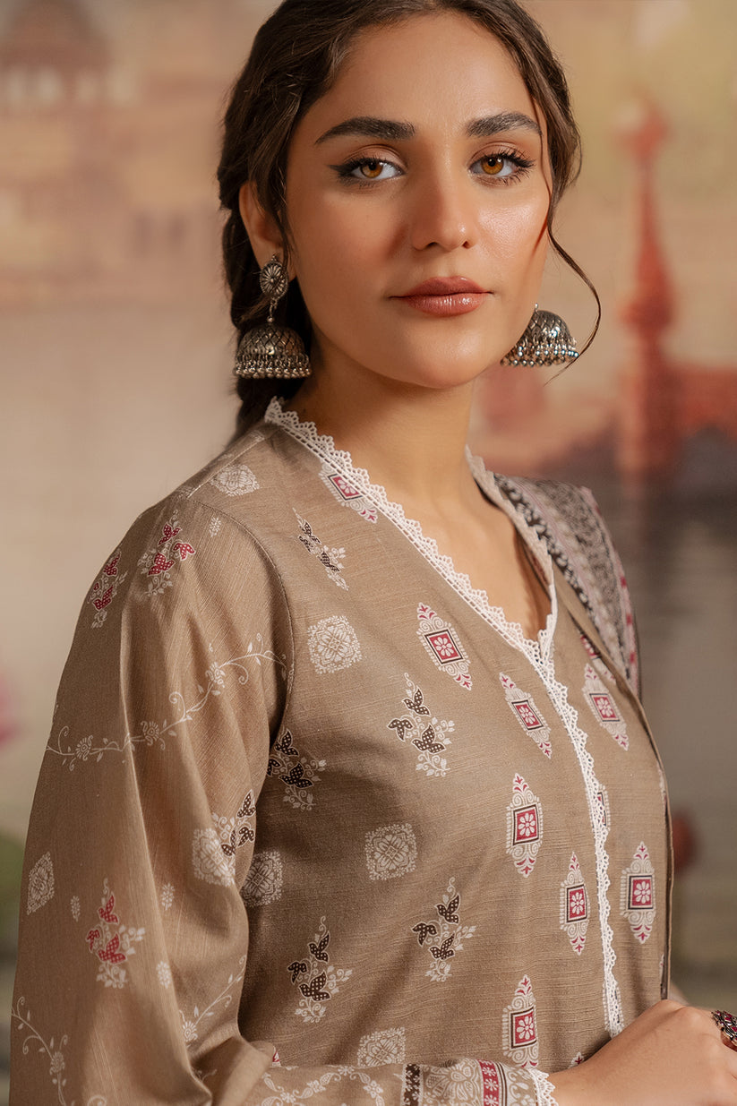 Woman wearing a patterned beige dress with a blurred background