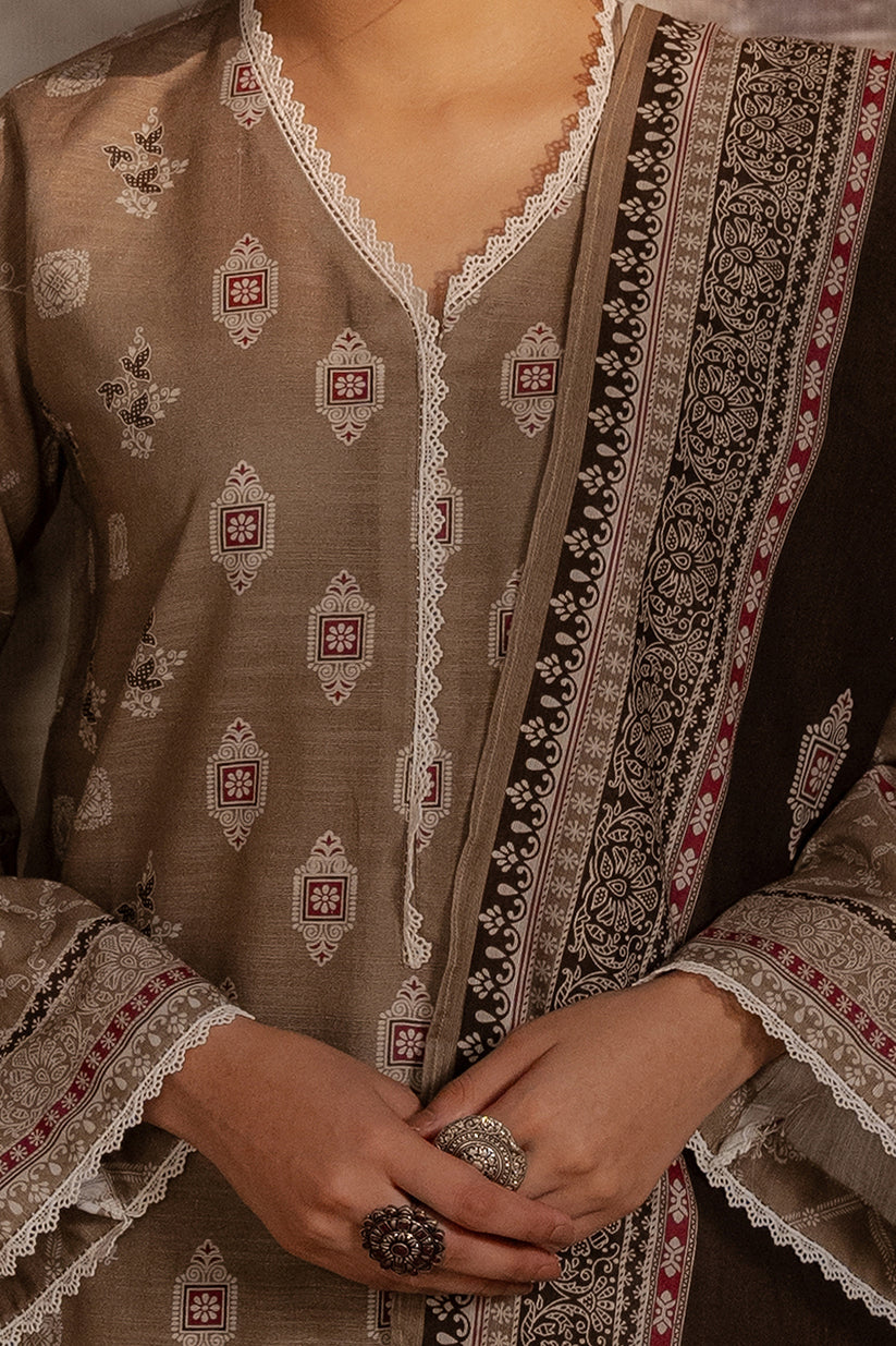 Close-up of a person wearing a traditional embroidered outfit with intricate patterns.