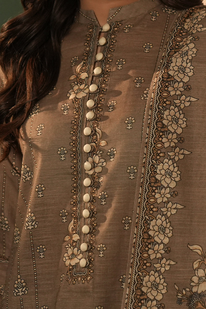 Close-up of a brown embroidered garment with floral patterns and white buttons.