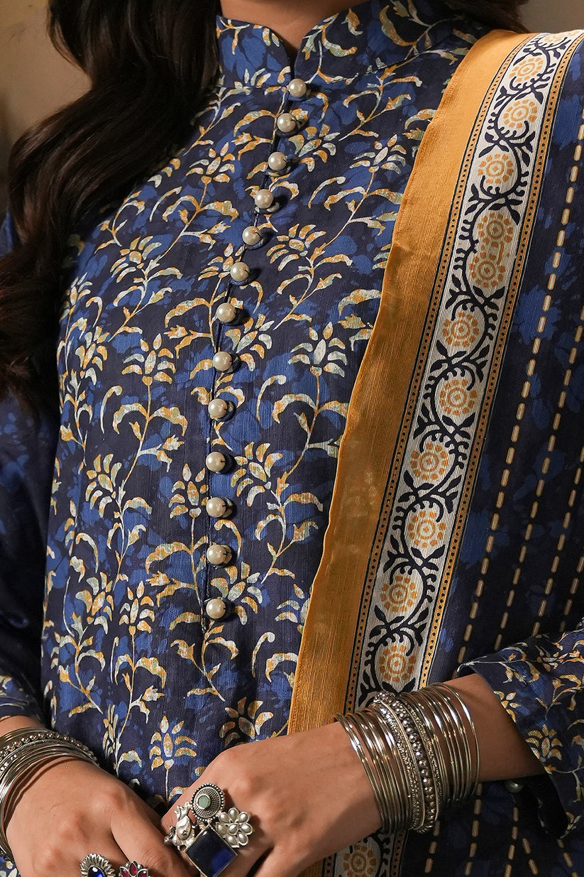 Person wearing a blue floral patterned outfit with a yellow border