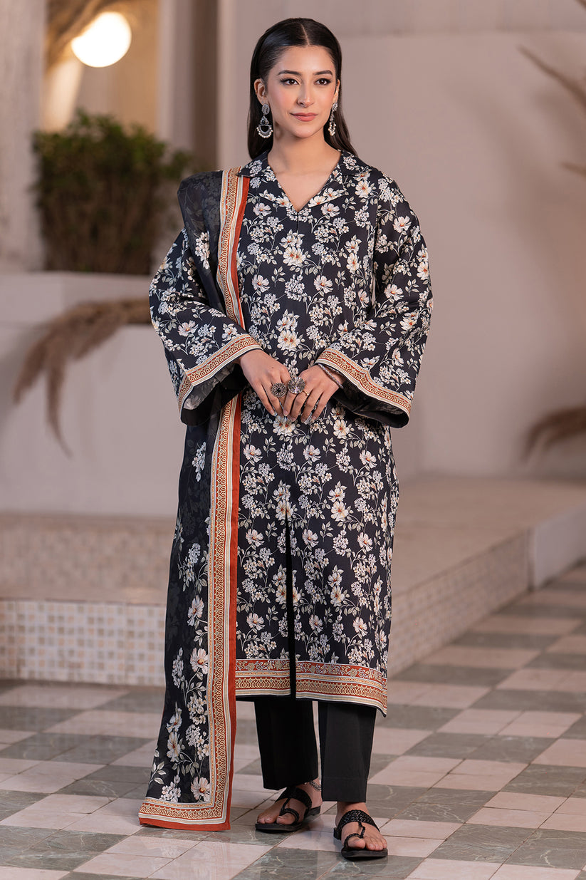 Woman wearing a floral dress with a matching dupatta in an indoor setting