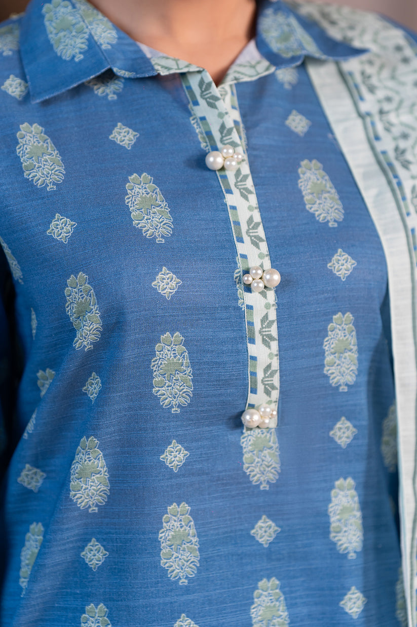 Close-up of a blue embroidered shirt with white patterns