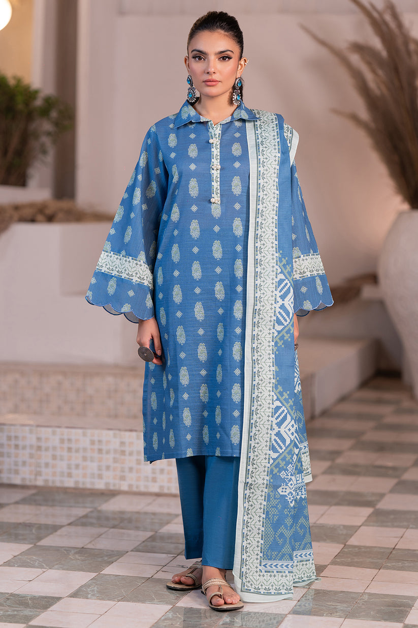 Woman wearing a blue traditional outfit with a matching dupatta in an indoor setting.