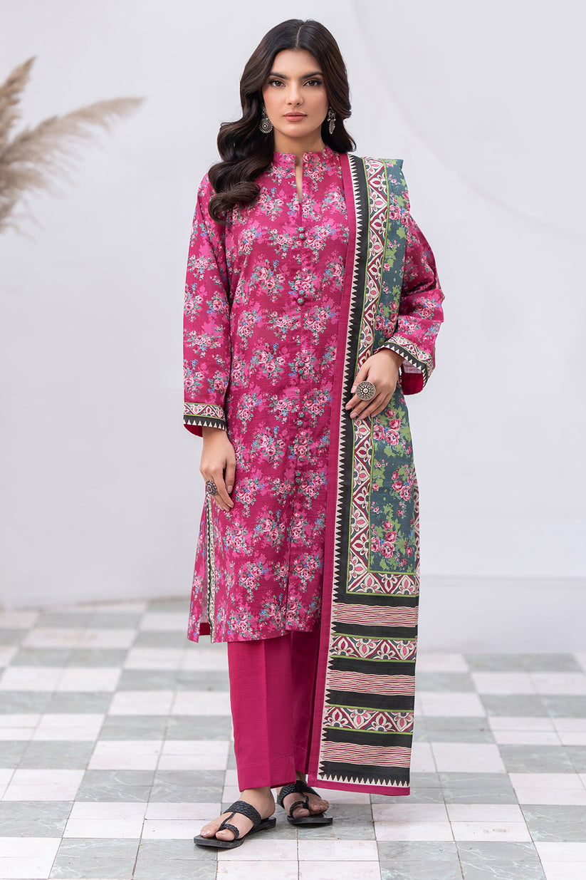 Woman wearing a pink traditional outfit with a patterned dupatta on a checkered floor.